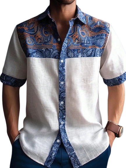 Man wearing a white short-sleeve shirt with blue and orange paisley pattern details.